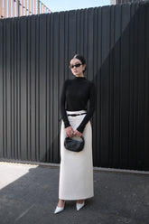 Long-sleeve knit top with mock neckline and seam detail for structured minimalist styling